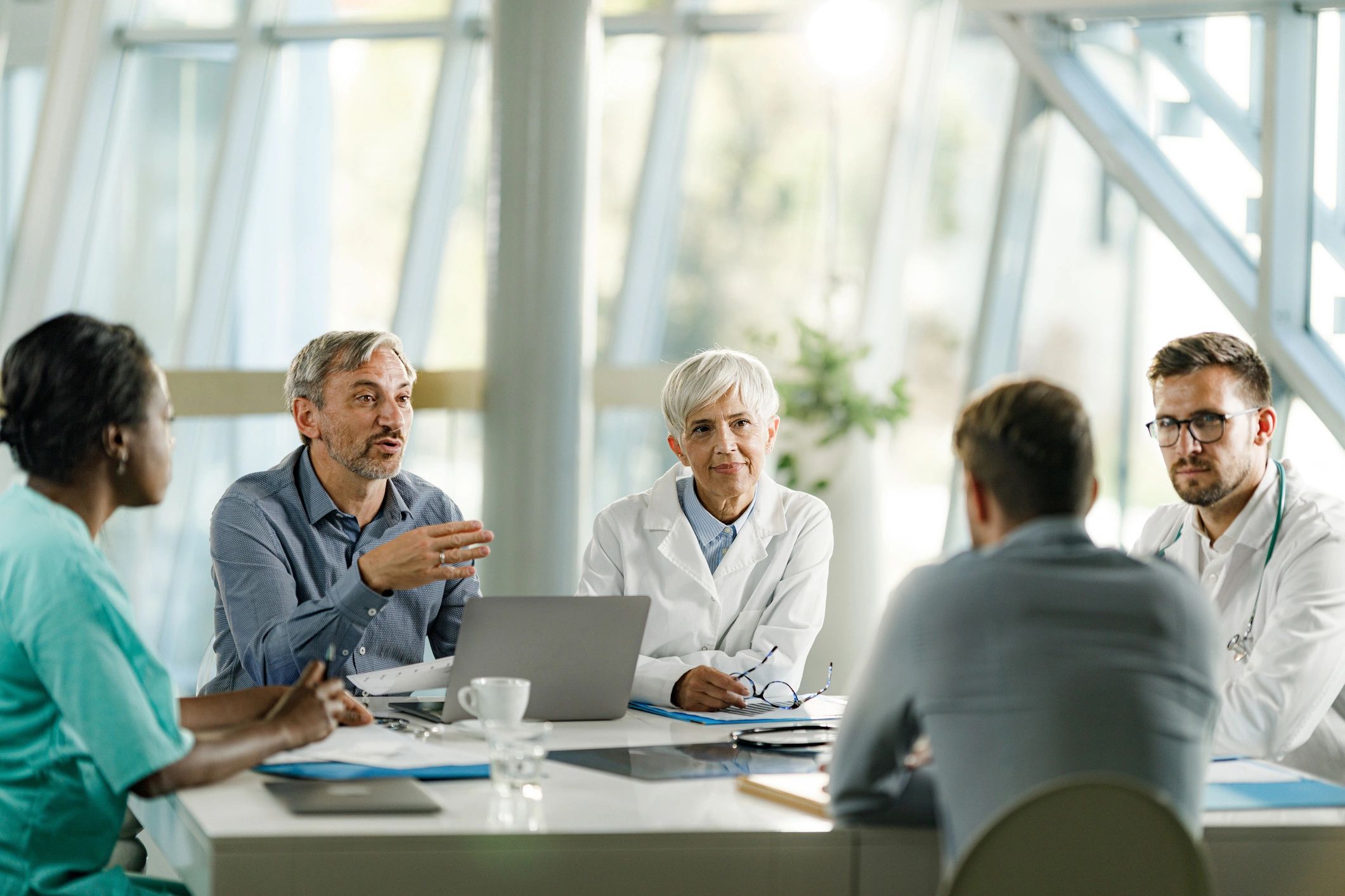 Healthcare consultants collaborating with leadership