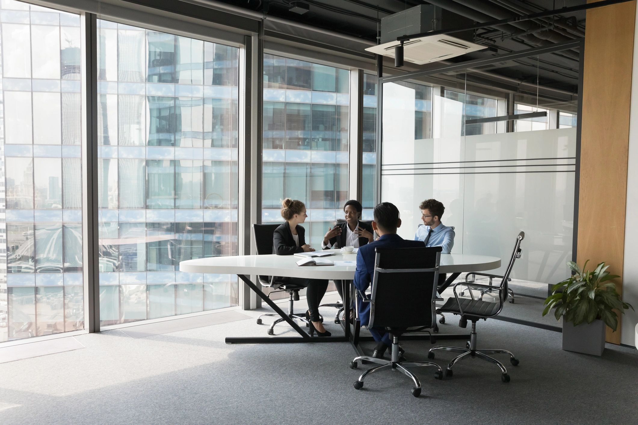 Consulting team discussing strategy in a modern meeting room